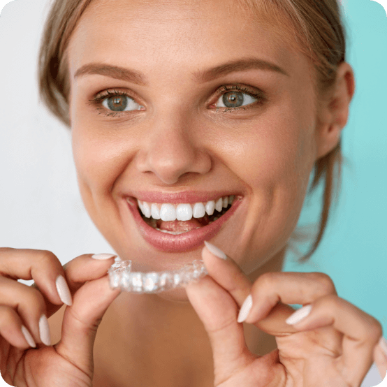 Woman using an at home teeth whitening tray