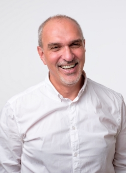 Smiling man in white collared shirt