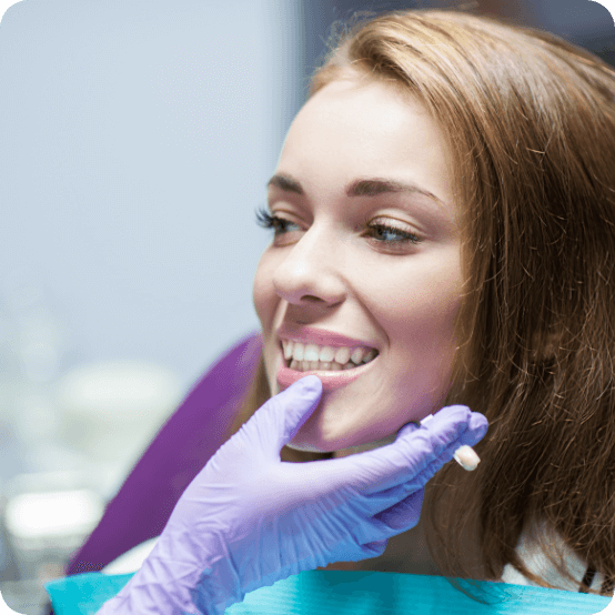 Dentist examining smile after restoration with dental crowns