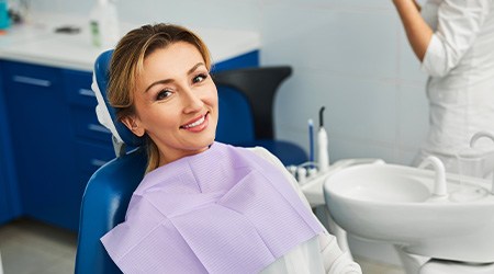 Woman smiling while sitting in treatment chair