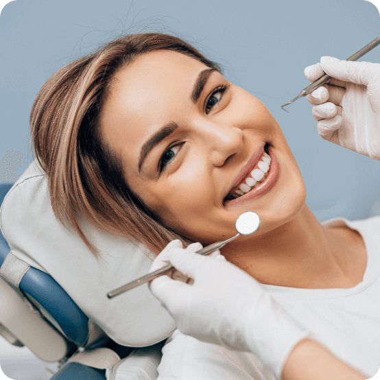 Woman smiling while receiving dental services in Eugene Oregon