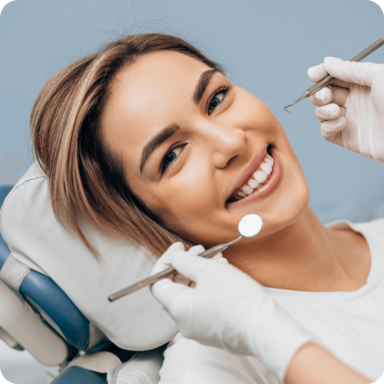 Woman smiling while visiting dental office in Eugene