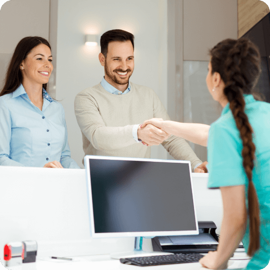 Friendly dental team member shaking hands with patient