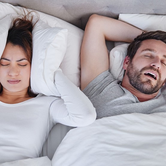 A snoring man keeping his wife awake