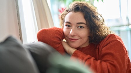 a woman smiling while feeling well-rested