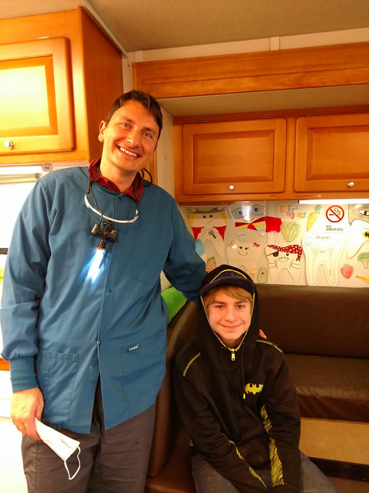 Dentist and young patient in dental office