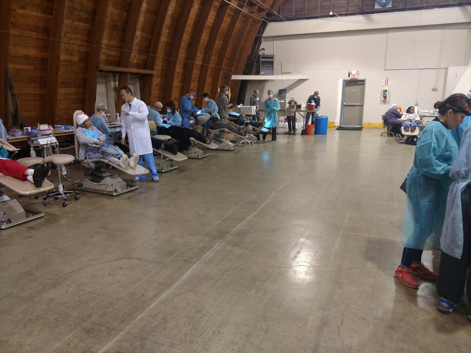 Row of dental treatment chairs in large open building