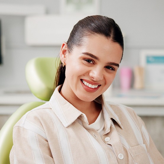 Happy patient looking at dental team member