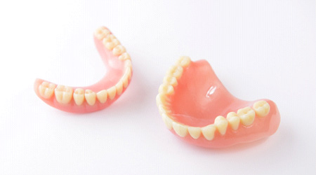 Set of full dentures in Eugene on a white background