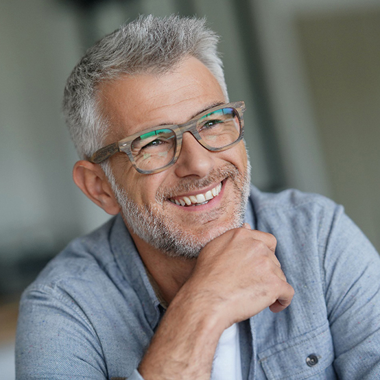 man wearing glasses and smiling