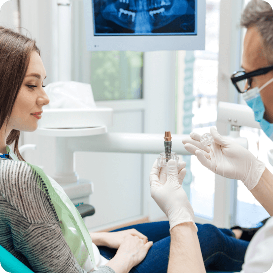 Dentist explaining the benefits of dental implants to a patient