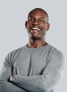 Man smiling and wearing gray shirt