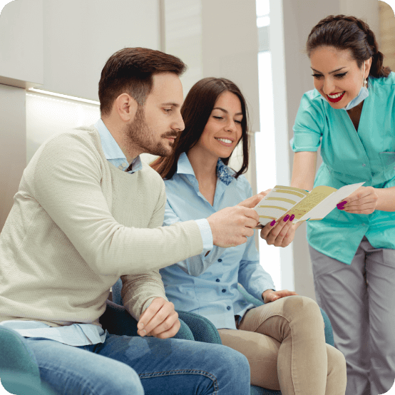 Dental patients and team member discussing dental insurance coverage