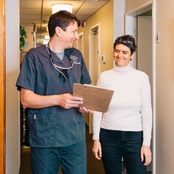 Eugene dentist walking down hallway with dental patient