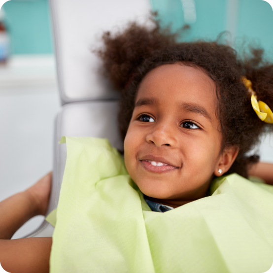 Child smiling during children's dental checkup and teeth cleaning