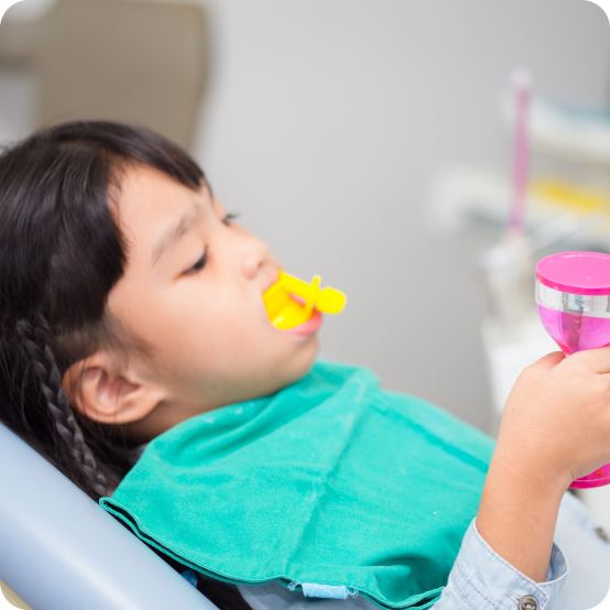 Child receiving fluoride treatment