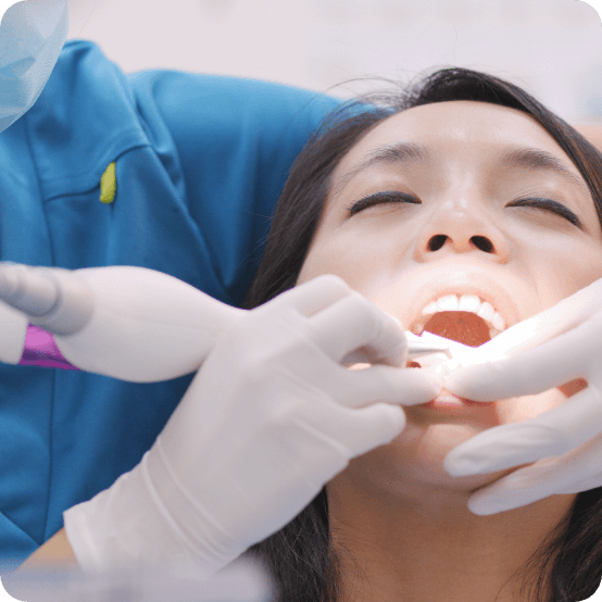 Dental patient receiving scaling and root planing periodontal disease treatment