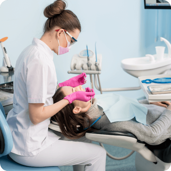 Dental team member giving a dental patient a dental exam