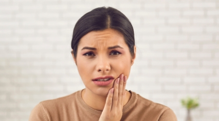 Woman in pain before tooth extraction