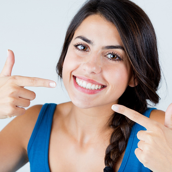 Woman smiling after cost of teeth whitening in Eugene