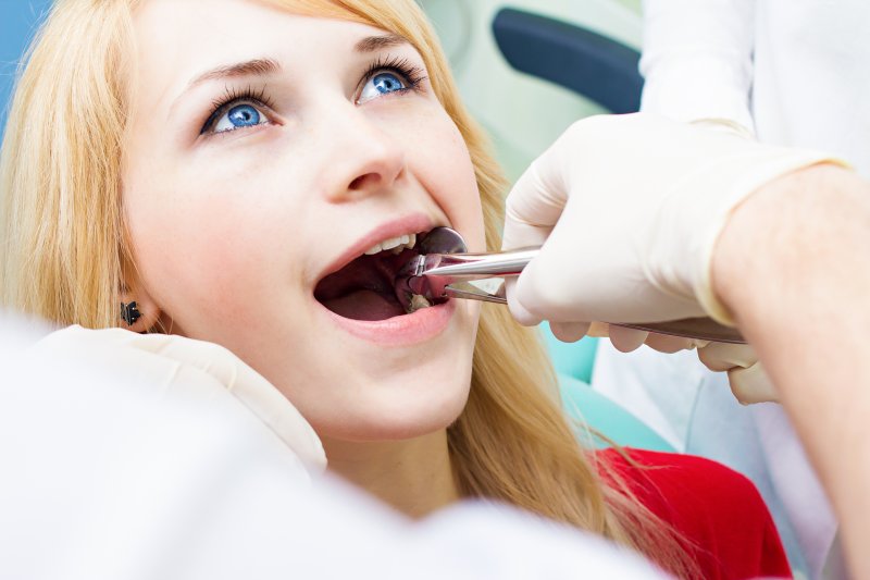 A young woman receiving a tooth extraction