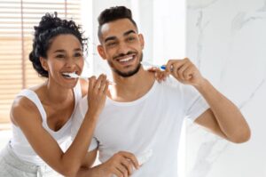 Couple brushing their teeth in bathroom 