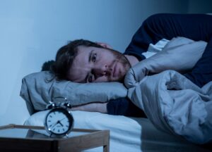 Man struggling to sleep in the middle of the night 