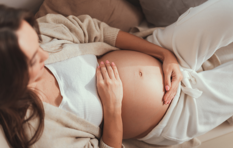 Pregnant woman holding belly
